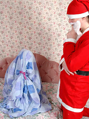 Big titted girl has sexual intercourse on a bed with Santa Claus