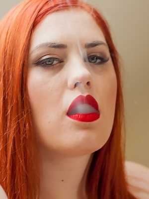 Big titted redhead Alexsis Faye sports red lips while smoking in her underwear