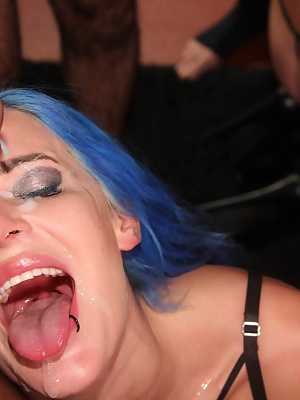 Pornstar Alexxa Vice sports dyed hair while on her knees for a blowbang scene