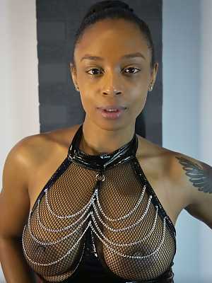 Ebony model Alicia Rhodes poses in a see-through top and over the knee boots