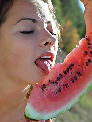 Cute solo girl Alisa B eats watermelon while posing in the nude