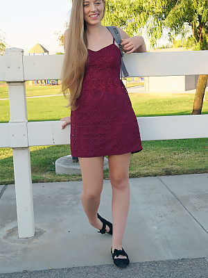 Petite teenage lady Alyce Anderson posing in her sexy dress outdoors