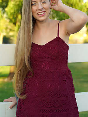 Petite teenage lady Alyce Anderson posing in her sexy dress outdoors