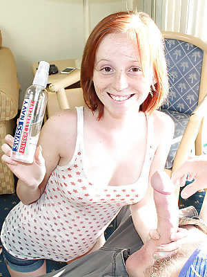 Nasty redhead teen pleasing a huge boner with her little hands and titties