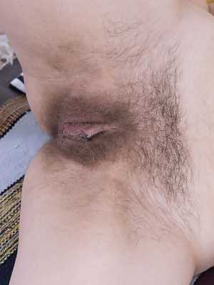 Russian beauty Amanda Clarke sucks a blue toy and inserts it in her hairy cunt
