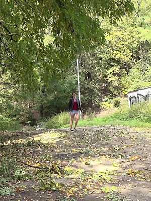 Distressed female Amanda Hill squats for an urgent pee on an earthen path