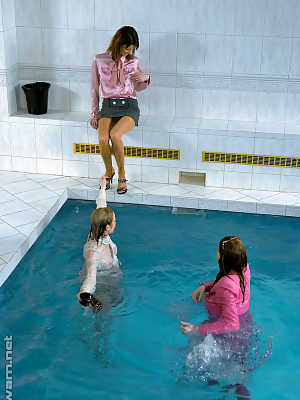 Fully clothed fetish ladies having some wet fun in the pool