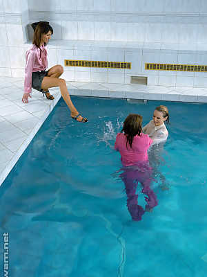 Fully clothed fetish ladies having some wet fun in the pool