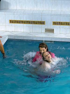 Fully clothed fetish ladies having some wet fun in the pool