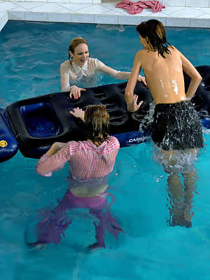 Fully clothed fetish ladies having some wet fun in the pool