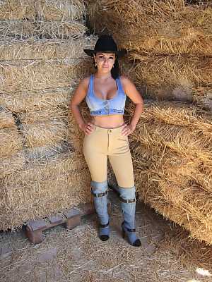 Cowgirl Amanda X displays pierced big tits & huge bubble butt in the stable