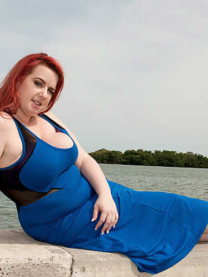 Redhead BBW Amerie Thomas runs water over her big tits after modeling a dress