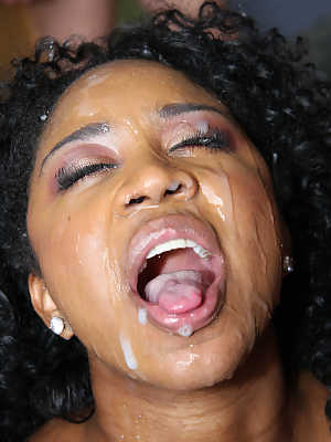 Ebony beauty Amile Waters gets her face covered with cum at a bukakke party