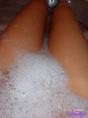 Teen solo girl Andi Land takes self shots during a bubble bath