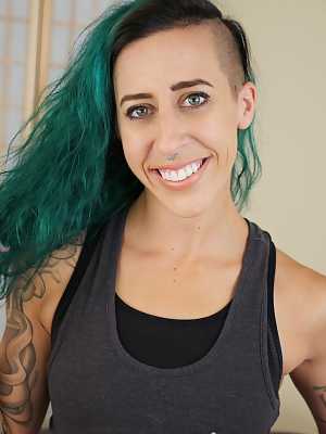 Andre Shakti with green hair exposes her tattooed body with small boobs