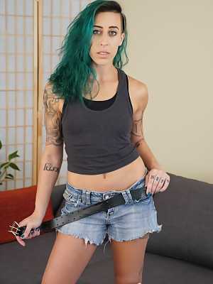 Andre Shakti with green hair exposes her tattooed body with small boobs