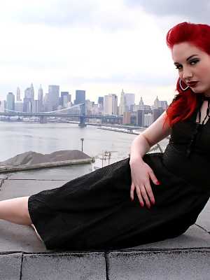 Redheaded model strips to back seam nylons and heels on a rooftop