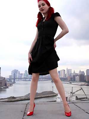 Redheaded model strips to back seam nylons and heels on a rooftop