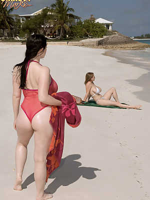 Big boobed lesbian Christy Marks seduces a busty female for sex on the beach