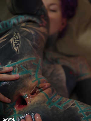 Heavily tattooed girl has her gaped anus fisted by her lover