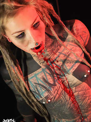 Totally tattooed girl Anuskatzz spits out blood after having her tongue split