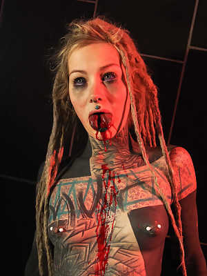 Totally tattooed girl Anuskatzz spits out blood after having her tongue split