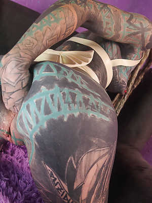 Heavily tattooed girl Anuskatzz fists her gaped asshole during solo action