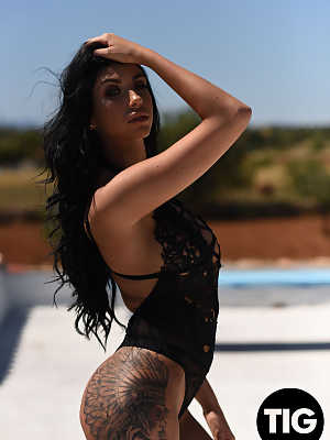 Tattooed teen in a black bodysuit Anya Leigh flashing her fake tits outdoors