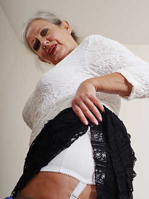 Blonde mature April reveals her big juggs & masturbates with a toy in lingerie