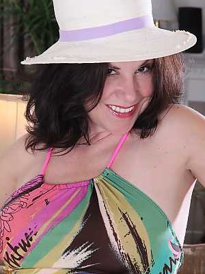 Mature MILF Arden Delaney striking sultry non-nude poses in dress and hat