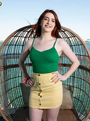 Pale redhead Aria Carson makes her nude debut on a waterside balcony