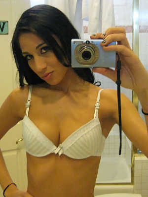 Petite dark haired Latina doll Aries Stone posing in bedroom and bathroom