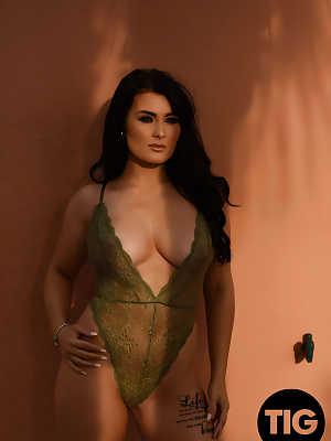 Curvaceous British model Ashleigh Gee removes sheer bodysuit outside and poses