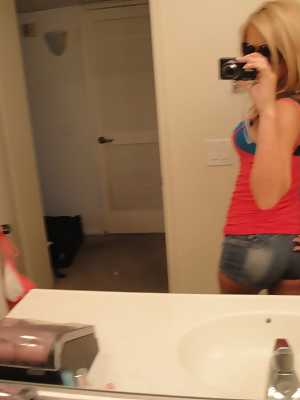 Cute blonde teen Ashley Abott snaps off self shots while undressing in mirror