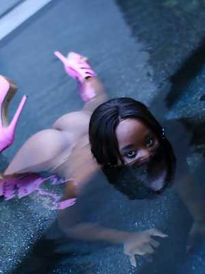 Black girl Ashley Pink exposes her bare ass as she emerges from a pool