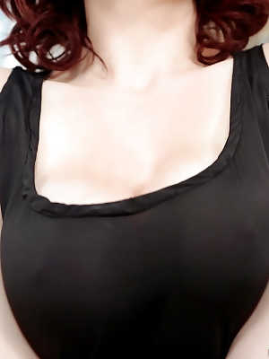 Redheaded babe Audrey Grace posing fully clothed in see thru black dress