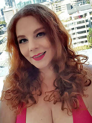 Chubby redhead Avalon sets her knockers free of a sports bra in pink hosiery