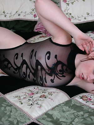 Cute amateur B4rbi3 in black sheer lingerie and stockings posing on the bed