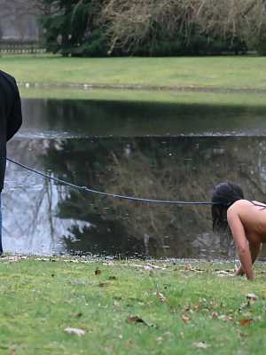 Female sub Barbara Devil crawls on a leash before being flogged on a cold day