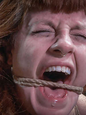 Redhead sex slave Barbary Rose is restrained by ropes during BDSM play