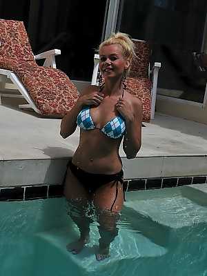 Cute blonde MILF Barbi Sinclair shows her fantastic body wearing sexy bikini in the pool.