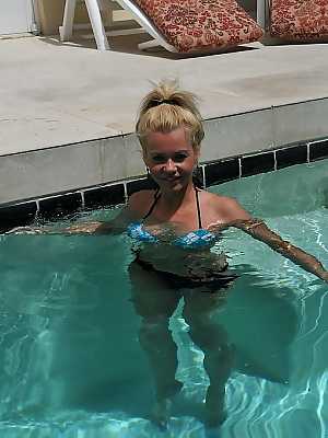 Cute blonde MILF Barbi Sinclair shows her fantastic body wearing sexy bikini in the pool.