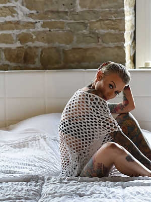 Gorgeous inked babe Becky Holt shows her tattoos and strips in a solo