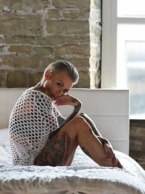 Gorgeous inked babe Becky Holt shows her tattoos and strips in a solo