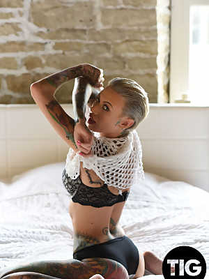 Gorgeous inked babe Becky Holt shows her tattoos and strips in a solo