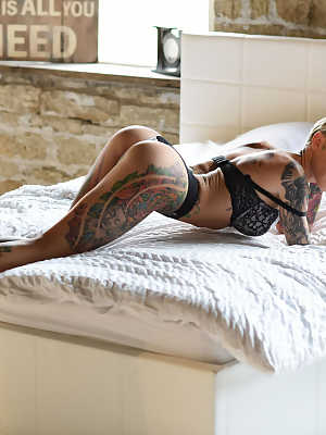 Gorgeous inked babe Becky Holt shows her tattoos and strips in a solo