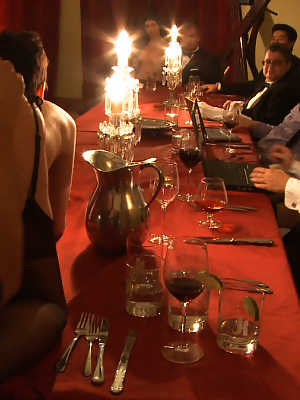 Female slaves treating the house guests to kinky under the table oral action