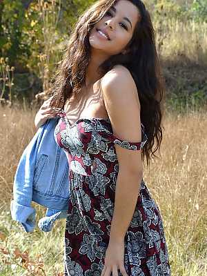 Latina first timer Bella Quinn covers up her exposed boobs in a field