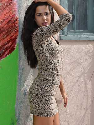 Dark haired Latina girl Bella Quinn models non nude in doorway wearing a dress