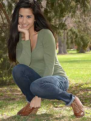 Latina chick Bella Quinn climbs a tree in the park wearing a sweater and jeans